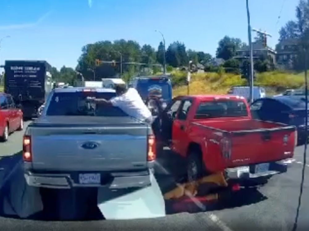 A man is seen discharging a can of pepper spray through the rear window of a Ford truck during a suspected road-rage incident in Surrey earlier this week. 