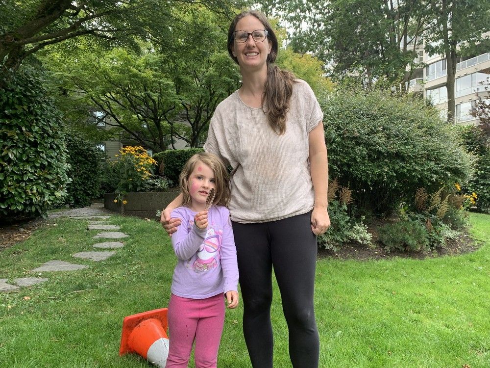  South False Creek co-op resident Sarah Pawliuk with daughter Willa, 4, says residents do not believe it is possible for the owner of 500 Starboard Square to develop his lot — which is now used as public space.