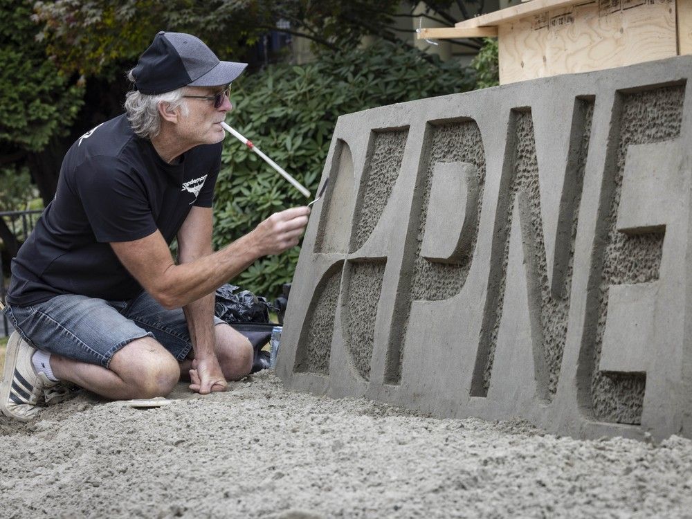 Sand sculptor Bruce Waugh from Sandemonz sand sculpture company puts the finishing touches on a sand sculpture at the PNE Thursday, Aug. 14, 2025.
