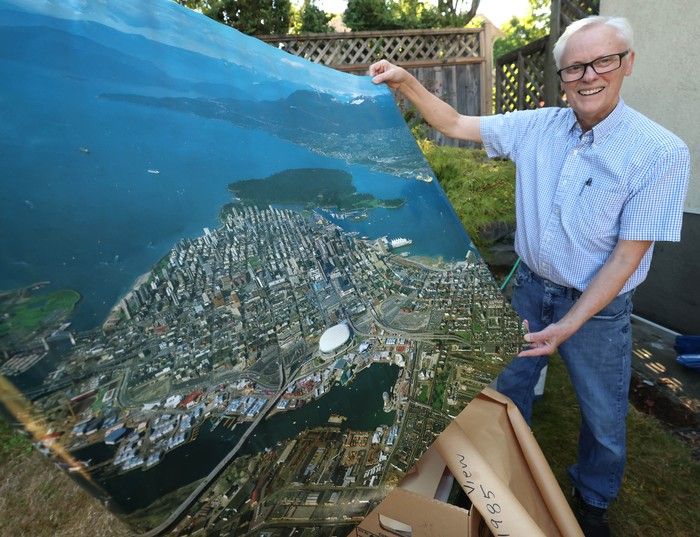  David Rogers with an aerial view poster of the Expo 86 site.