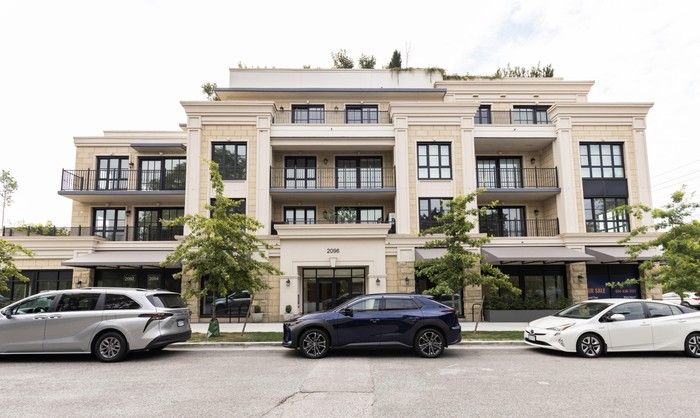  The Chloe building features an elegant, soft-palette facade features large, framed apartment windows and long, narrow balconies.