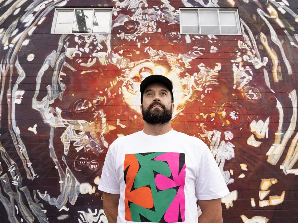 Drew Young with his art outside of the Astro Club artist facility in Vancouver.