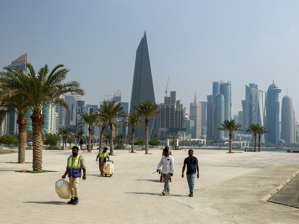 People on Qatar's capital Doha's seaside corniche on Wednesday. A B.C. prison escappe was arrested there last week, but RCMP are remaining mum, likely because of sensitive talks with a country that Canada has not extradition treaty with.