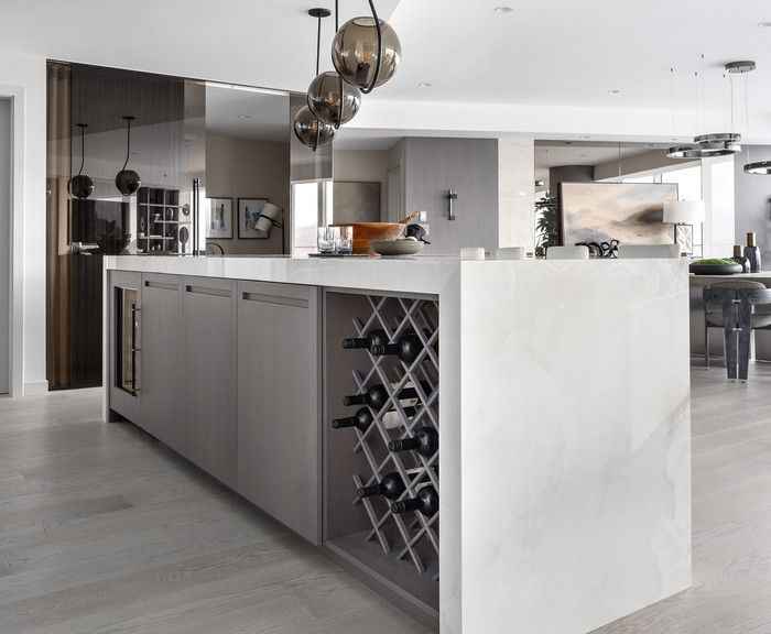  The kitchen has a wedge-shaped island with a wine rack at one end.