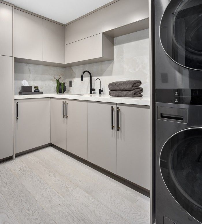  In the laundry room, an LG WashTower frees up floor space for extra cabinetry, while Emtek hardware and Brizo fixtures add refinement.