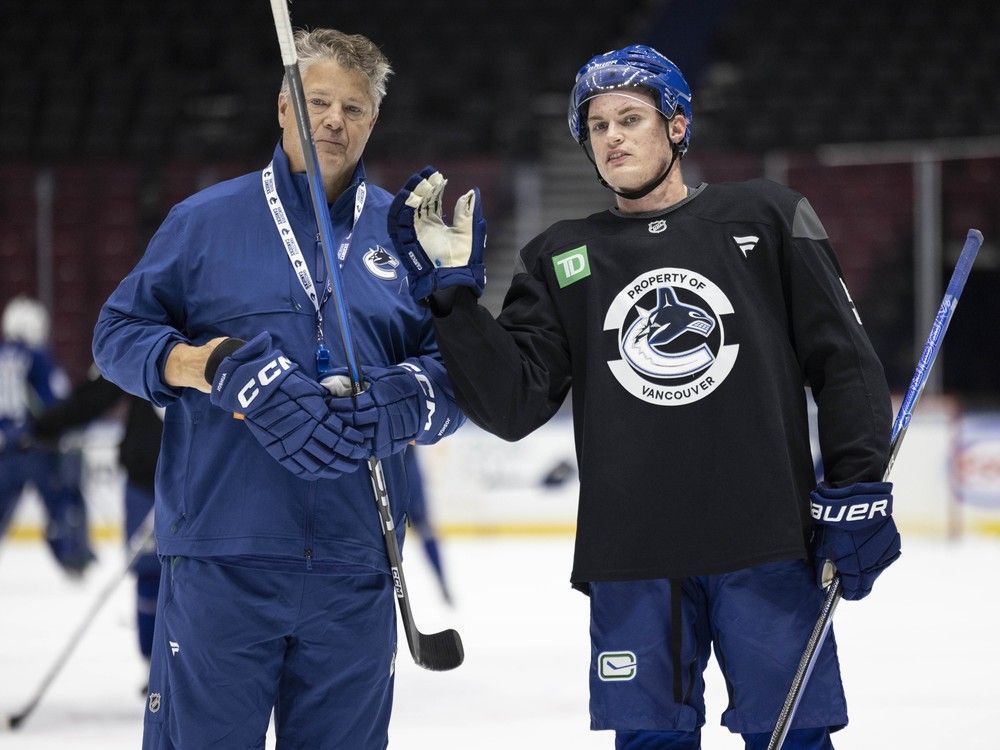 Vancouver Canucks Tom Willander (right) with assistant coach Kevin Dean at team practice at Rogers Arena in Vancouver on Sept. 25, 2025.