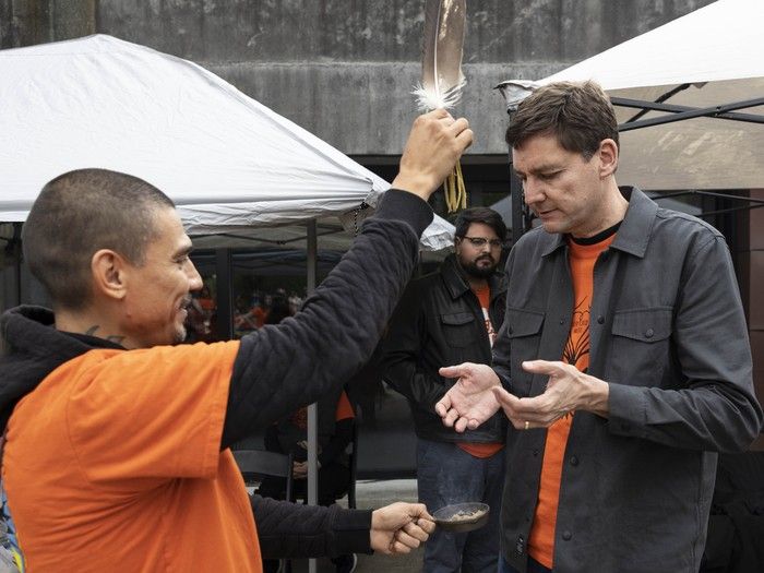 Mitchell Tourangeau (left) performs at smudging ceremony on Premier David Eby at the events marking the National Day for Truth and Reconciliation at UBC on Tuesday. Mitchell Tourangeau (left) performs at smudging ceremony on Premier David Eby at the events marking the National Day for Truth and Reconciliation at UBC on Tuesday.