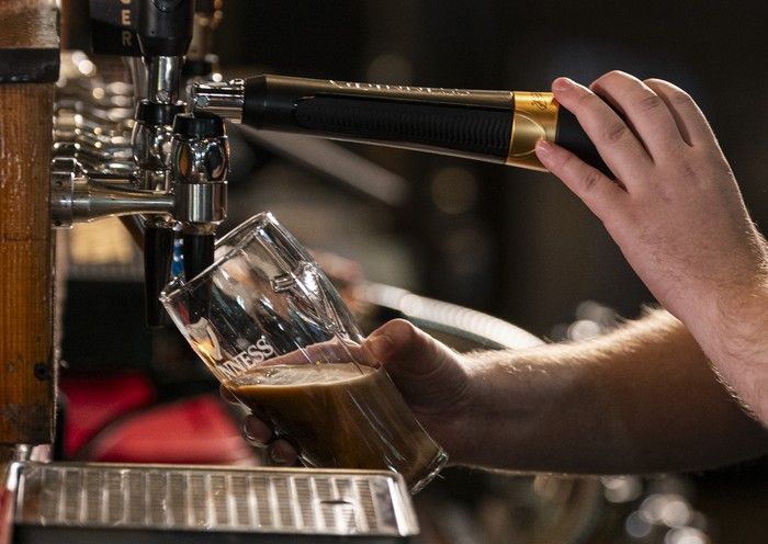  cial doyle, a bartender at donnellan’s irish pub, pours a pint of guinness in vancouver on friday.