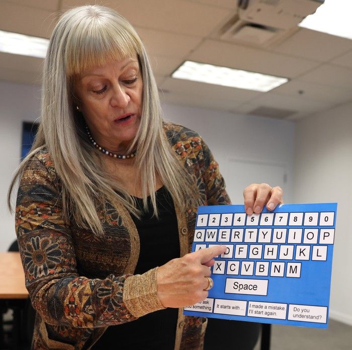  lois turner, a program manager at caya, communication for youth and adults, shows examples of adaptive technologies for people losing their speech and other cognitive challenges.