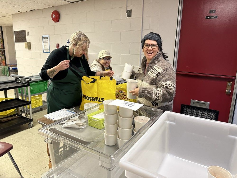 Breakfast supervisor Bonnie Jarvis fills up a shopping bag with breakfasts for Strathcona elementary teacher Lourdes Friess to take to her class in 2024. In the background is volunteer Vuong My. Breakfast supervisor Bonnie Jarvis fills up a shopping bag with breakfasts for Strathcona elementary teacher Lourdes Friess to take to her class in 2024. In the background is volunteer Vuong My.