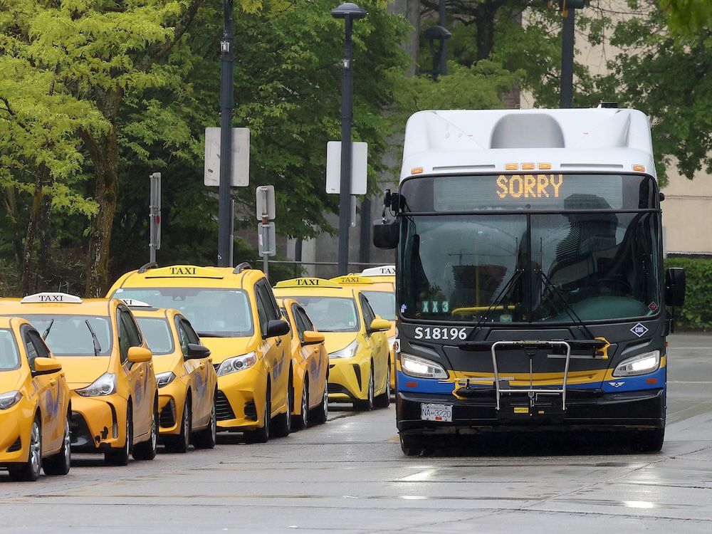 A bus drives down a street in Surrey. A bus drives down a street in Surrey.