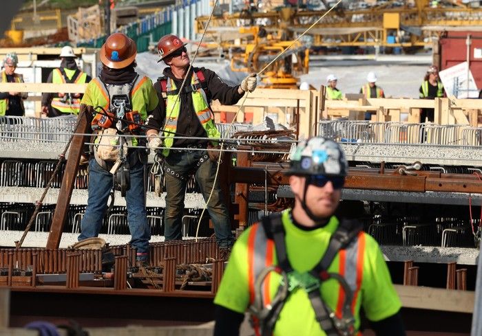 More than 400 workers working 24 hours a day to meet the approaching deadline to complete the bridge. More than 400 workers working 24 hours a day to meet the approaching deadline to complete the bridge.