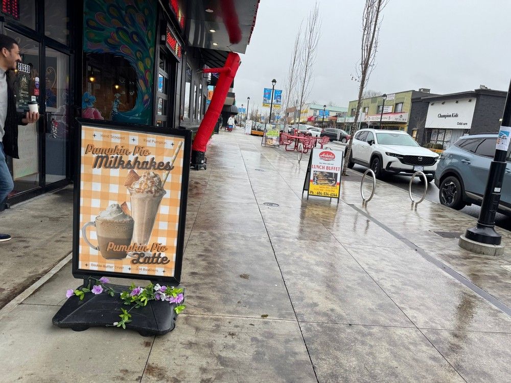 Signs for local food businesses are pictured on Fraser Highway in Langley.