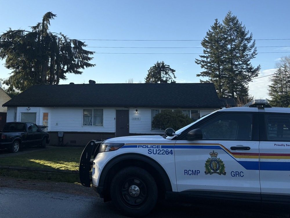 An RCMP vehicle is stationed in front of a home in the 11000-block of 140A Street of Surrey on Dec. 31. The home has been targeted by gunfire three times this month.