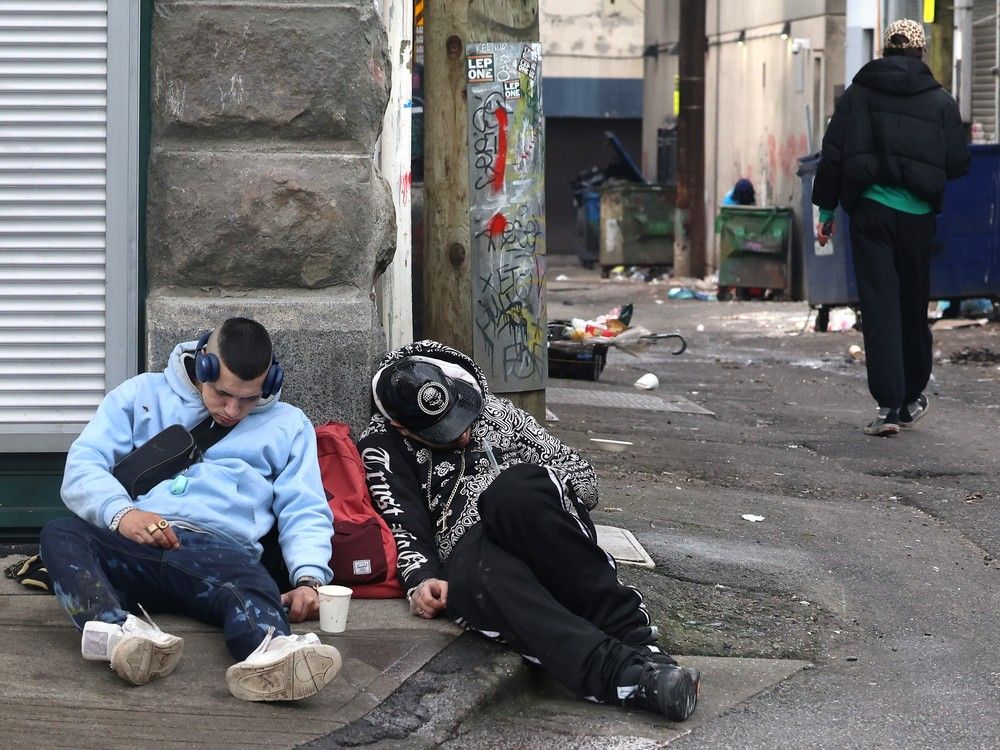 Two people lay on a street in Vancouver's Downtown Eastside on Jan. 27.