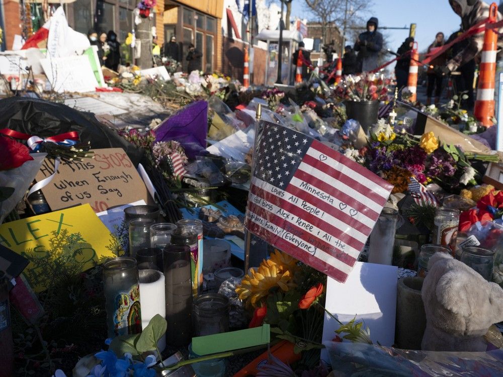 People gather at a makeshift memorial in the area where Alex Pretti was shot dead by federal immigration agents in Minneapolis, Minnesota, on Jan. 28, 2026.