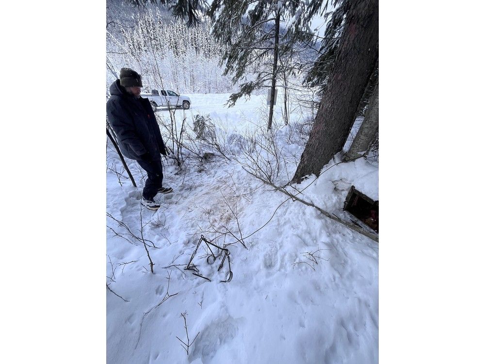  Sean Boxall stands with the animal trap that killed his Siberian husky Moon near Radium Hot Springs on Jan. 8.