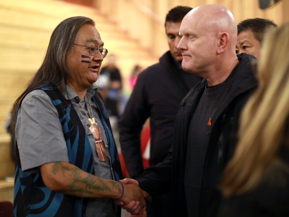  Vancouver Police Chief Const. Adam Palmer shakes hands with the Maxwell Johnson following the ceremony at the Big House in Bella Bella, B.C., on Monday, October 24, 2022.