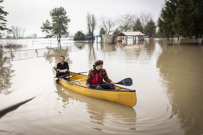  Fog envelops DeLair Park on Old Yale Road in Abbotsford on Dec. 13, 2025, as Truman Proudfoot (stern) and Caleb London (bow) take advantage of flood waters to paddle around the park.