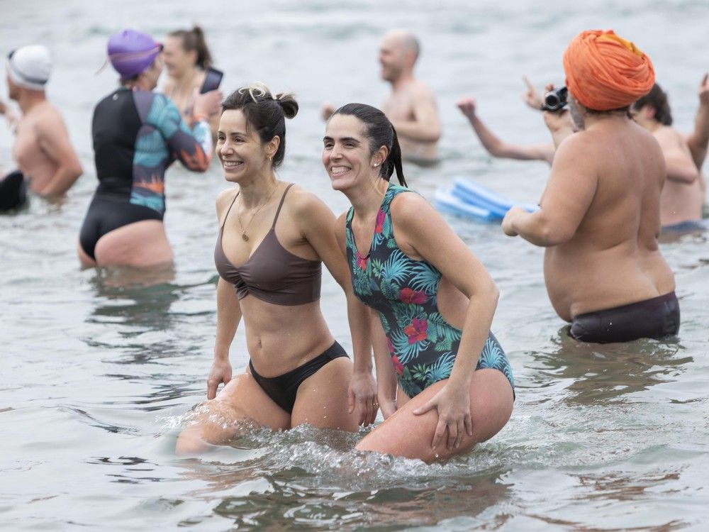 People brave the cold waters in English Bay for the Polar Bear Swim in Vancouver on January 1, 2026.