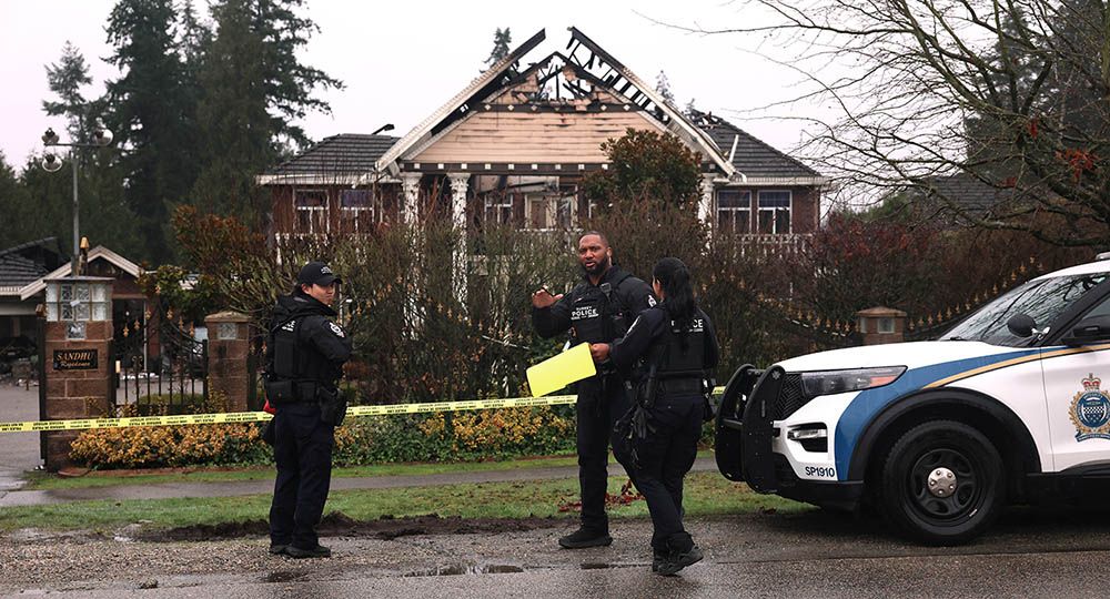  Surrey police gather evidence after a fire at 12732 56th Ave. in Surrey. A man was found dead inside and IHIT has taken over the case.