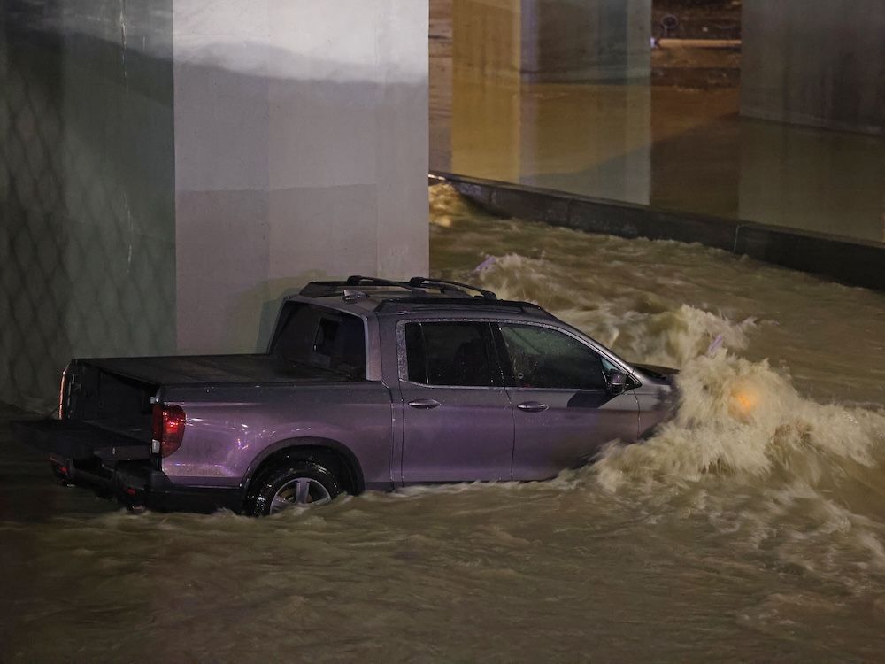 A major water main break flooded a large section of 16th Avenue in Montgomery and Bowness streets stranding about 10 vehicles in the floodwater on Dec. 30.