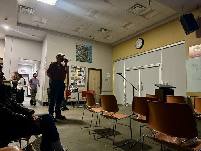  Volunteer Ben Rampre is pictured on the microphone during a Feb. 1 karaoke night at the UGM.