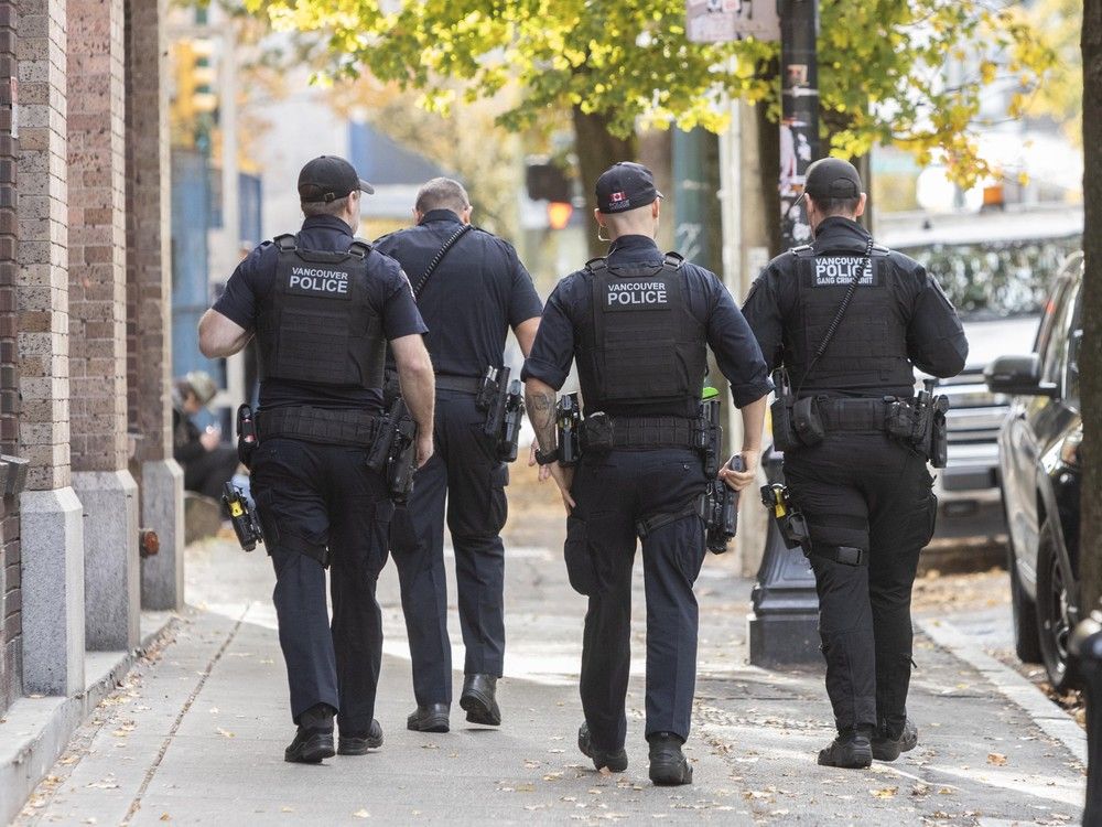Vancouver Police officers walk the Downtown Eastside (DTES) in Vancouver, BC, November 3, 2025.