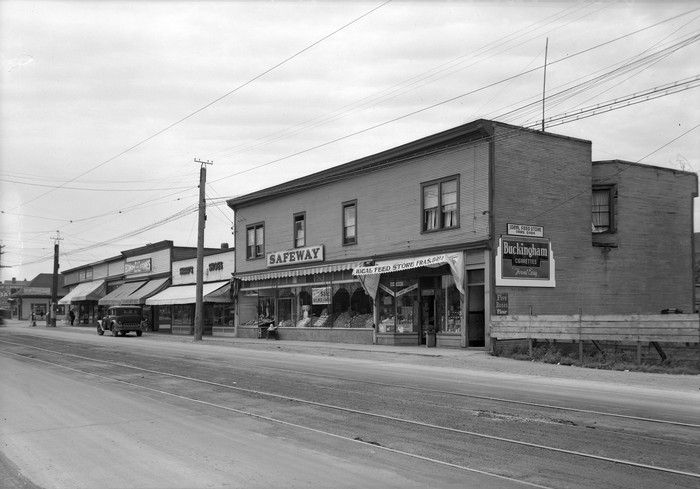 June 1939: View looking southwest in 5600 block Victoria near E. 41st. Businesses included are Canada Safeway Ltd. and Ideal Feed Store.