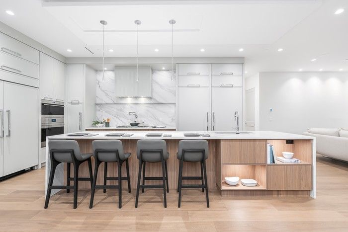  Gourmet kitchen with Wolf and Sub-Zero appliances, an oversized island with waterfall countertops.