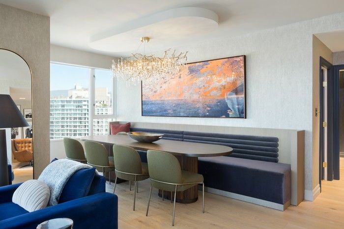  In the home’s dining area, an oval Radius dining table by Union Wood Co. pairs with slim dining chairs by Four Hands, while built-in bench seating by WD Western Designer nods to classic supper-club style and keeps sightlines open toward nearby living spaces.