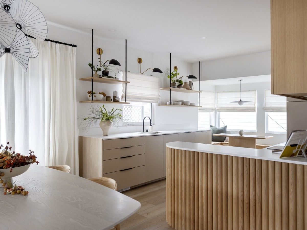 A layered mix of solid wood, veneer and laminate gives this kitchen designed by Schédio Spaces warmth and texture.