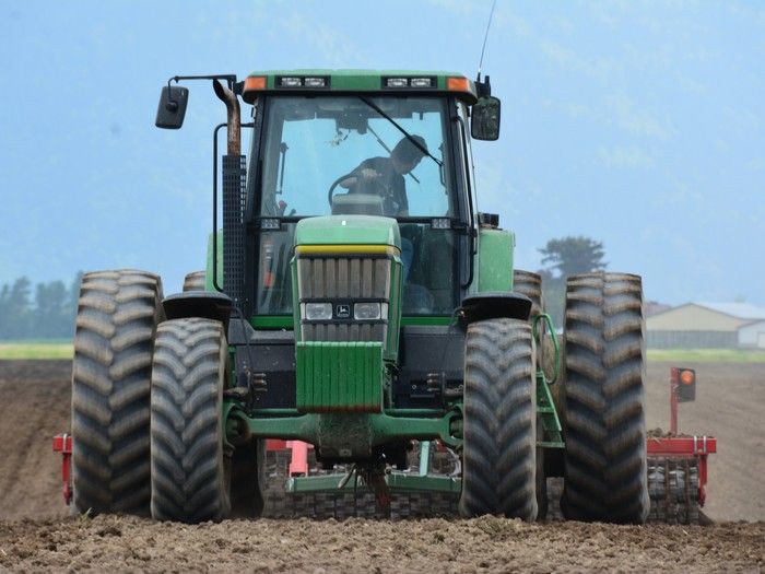  A farmer prepares a field for planting.