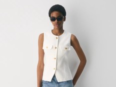 Woman wearing a white Babaton Correspond tweed vest, $128 at Aritzia, aritzia.com.
