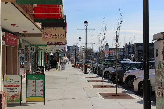 2026: Looking east down a sidewalk along the one-way stretch of Fraser Highway in Langley City.