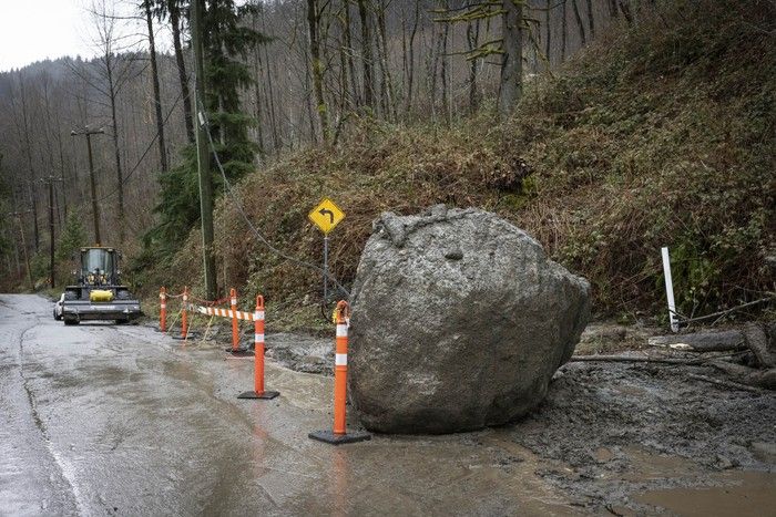 A large boulders that was part of a mudslide awaits removal as crews deal with debris that blocked Pipeline Road, in Coquitlam last week.