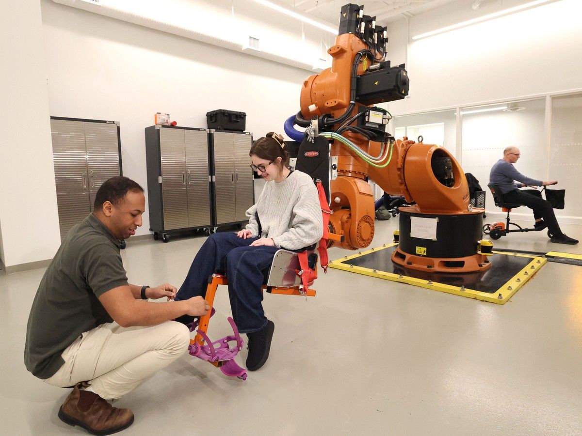 Dr. Peter Cripton (r) and Sophia Katramadakis with the SIMON Robot Facility at the  the UBC School of Biomedical Engineering in Vancouver.