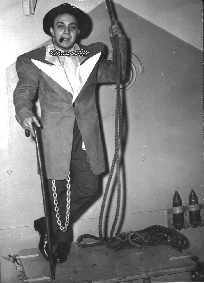  Feb. 3, 1945. Original cutline: This is how a sailor looks in a suit-zuit. Leading stoker Ralph (unknown, might be Umbriaco) of Montreal, serving in HMCS Blackmore put that suit on to show his ship’s mates that anything pertaining to zoot should be called taboo aboard a Canadian warship. R.C.N. photo, petty officer Guy Goulet.