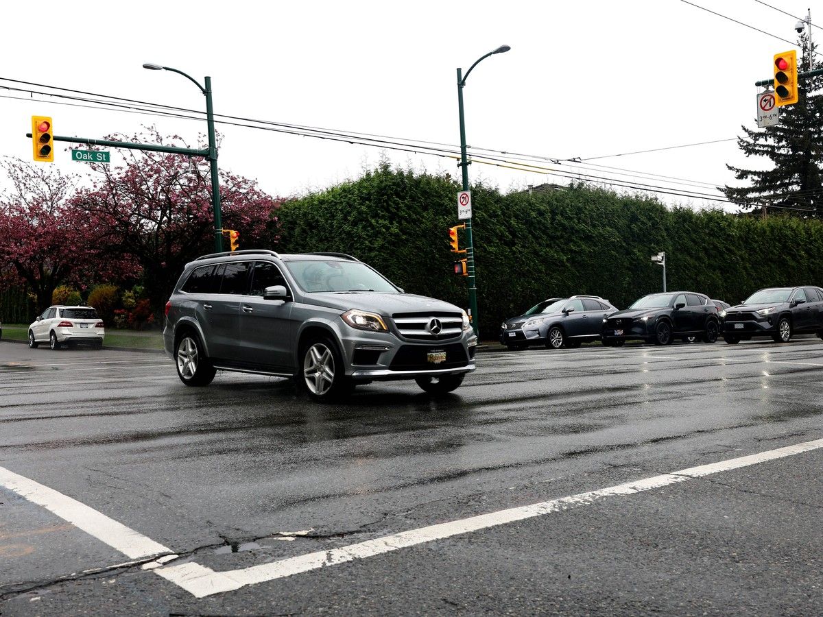 A car runs a red light at Oak St. and 57th Ave. The intersection has the highest numbers for speeding tickets and running red lights, in Vancouver.