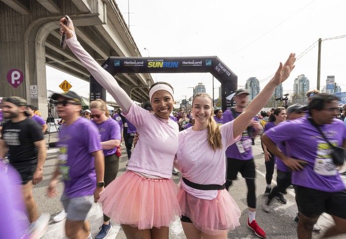 Finishers celebrate after crossing the finish line at the 2026 Vancouver Sun Run in Vancouver on April, 19, 2026.