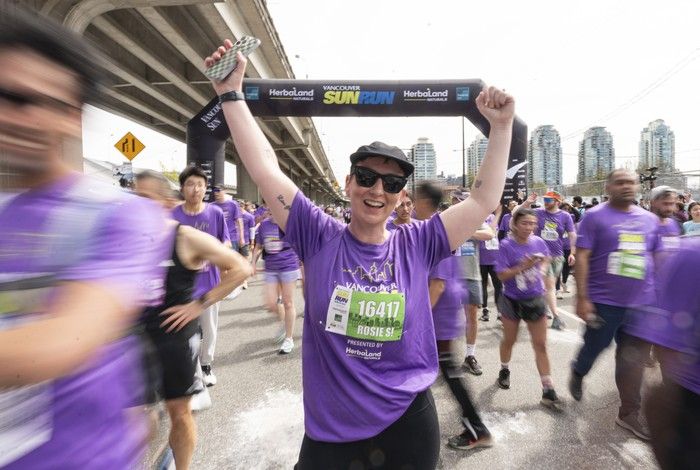 Finishers celebrate after crossing the finish line at the 2026 Vancouver Sun Run in Vancouver on April, 19, 2026.