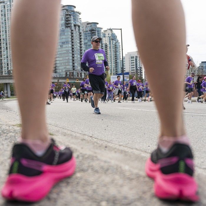 A supporter cheers on runners along the course at the 2026 Vancouver Sun Run in Vancouver on April, 19, 2026.