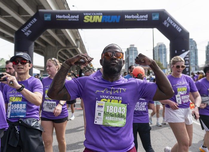 Finishers celebrate after crossing the finish line at the 2026 Vancouver Sun Run in Vancouver on April, 19, 2026.