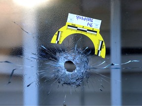 A bullet hole in a window at the scene of an extortion-related shooting in Surrey in October 2025.