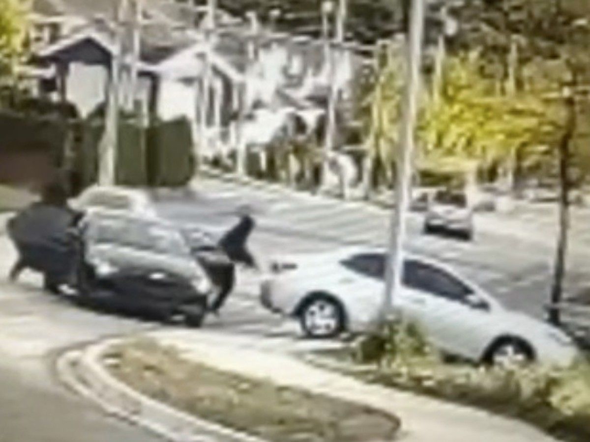 The dead victim was left hanging out of a silver-coloured vehicle, cash on the ground in front of him, according to a photo sent to Postmedia