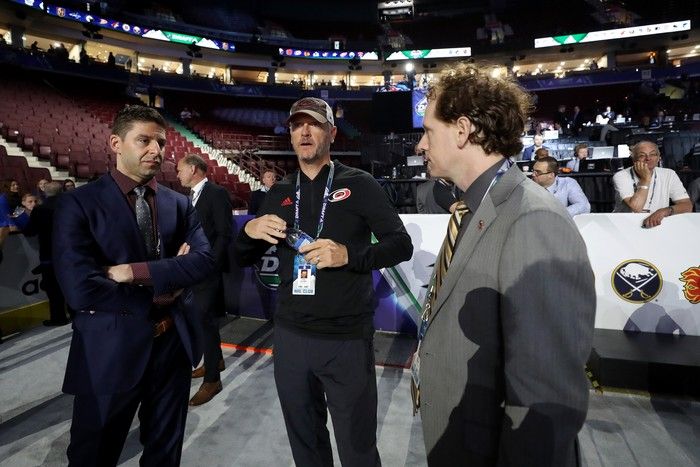 Tom Dundon (centre) of the Carolina Hurricanes attends the 2019 NHL Draft at Rogers Arena in Vancouver.