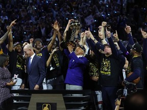 Denver Nuggets owner Stan Kroenke raises the Larry O'Brien Championship Trophy after a 94-89 victory against the Miami Heat in Game 5 of the 2023 NBA Finals.