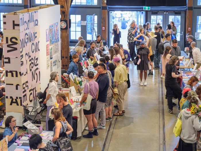 Crowds of people look at the tables set up at the Vancouver Art Book Fair.