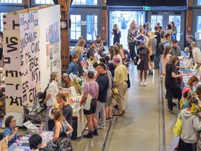 Crowds of people look at the tables set up at the Vancouver Art Book Fair.