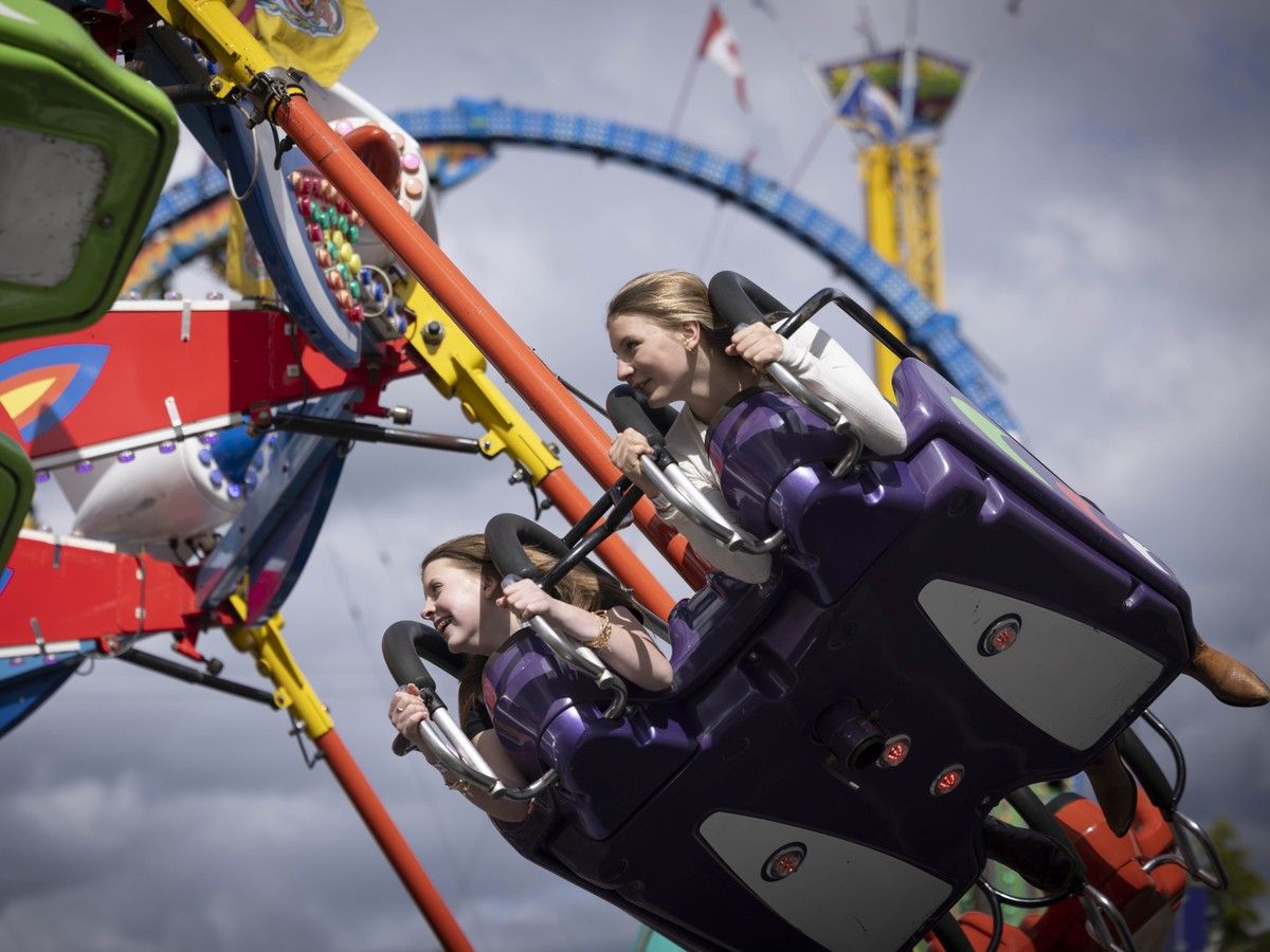 Attendees fly high on fairground rides at the annual Cloverdale Rodeo and Country Fair.